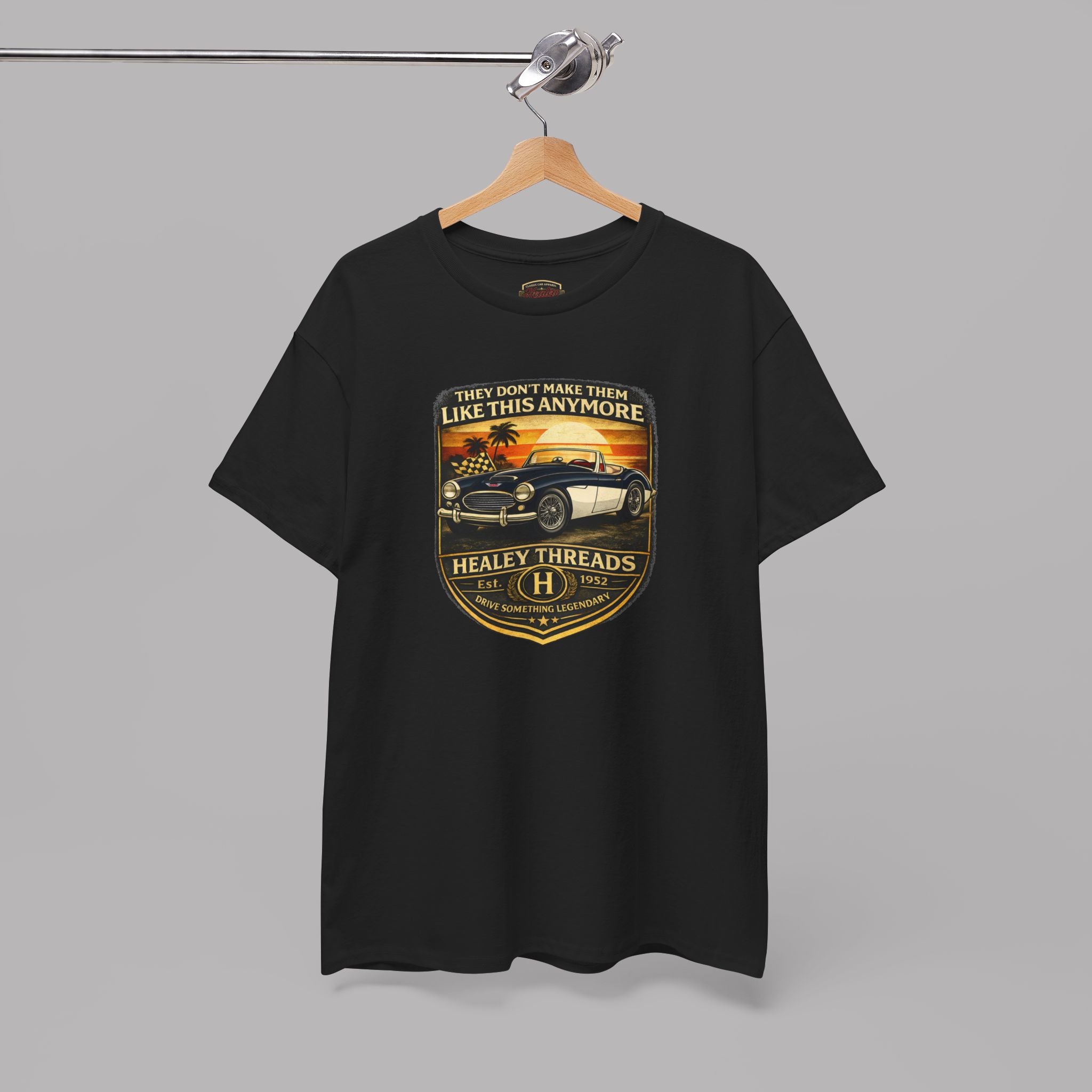 Black t-shirt with a graphic car design on a hanger against a gray background