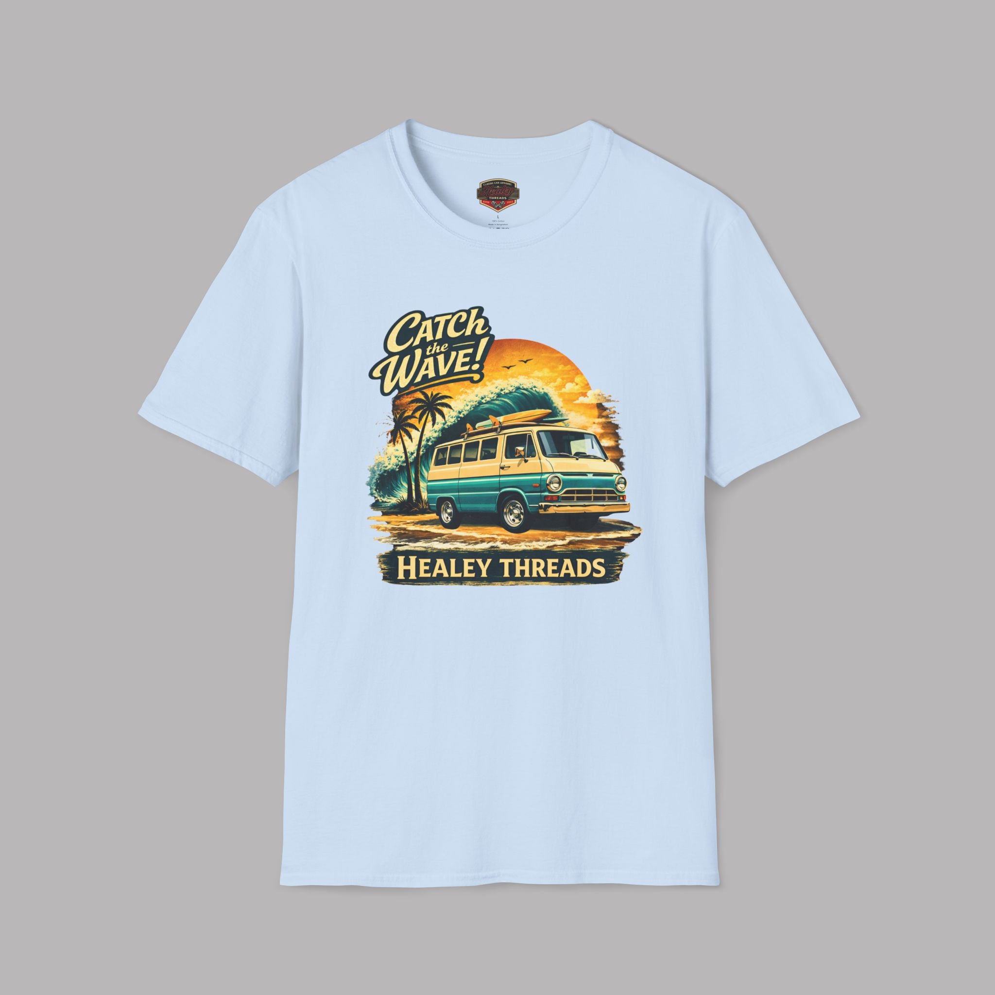 Light blue t-shirt with a graphic design of a van and palm trees on a gray background