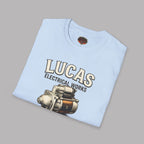 Folded Light blue t-shirt with 'Lucas Electrical Works' graphic on a gray background