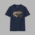 Navy blue t-shirt with car graphic and text 'Drive it. Don't park it.' on a gray background