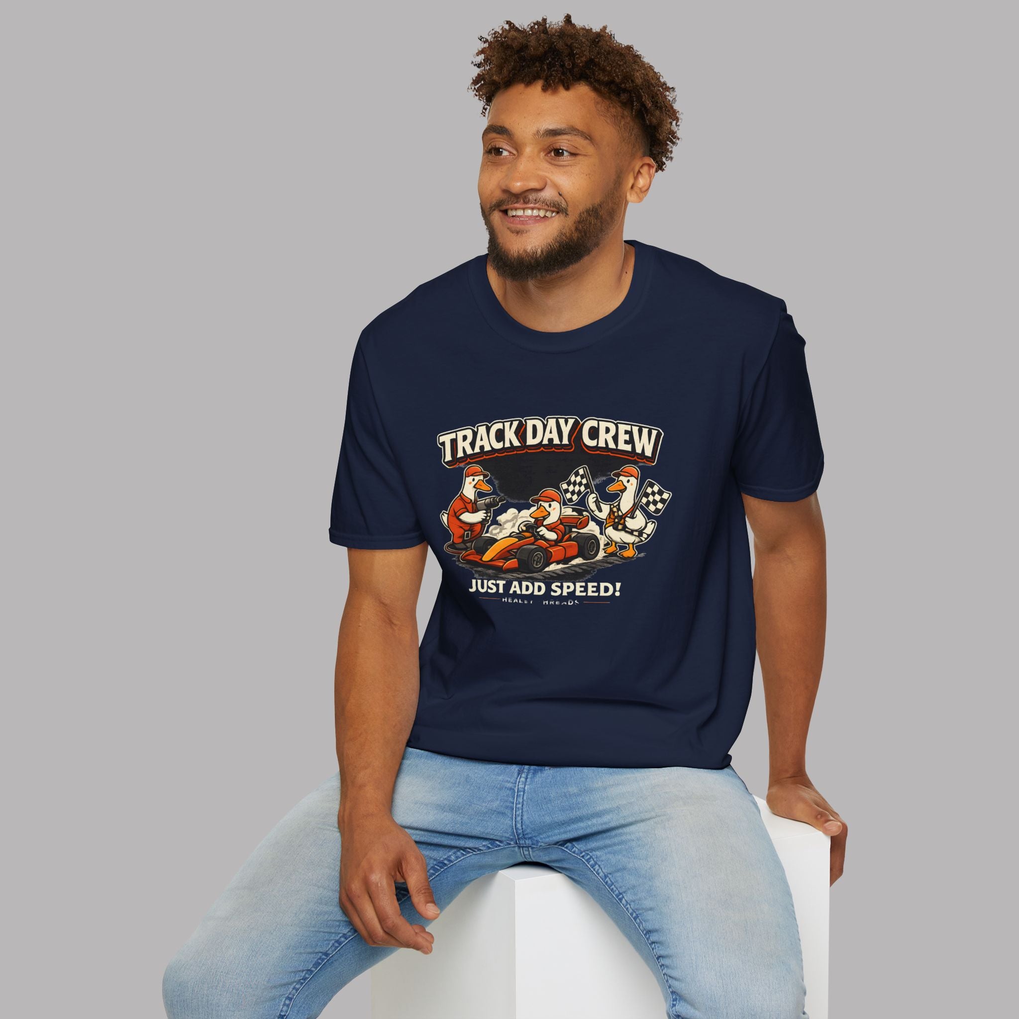 Man wearing a navy blue t-shirt with 'Track Day Crew' graphic design on a gray background