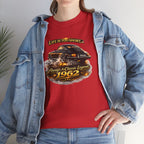 Woman wearing a red t-shirt with a classic car graphic design and text, paired with a denim jacket.