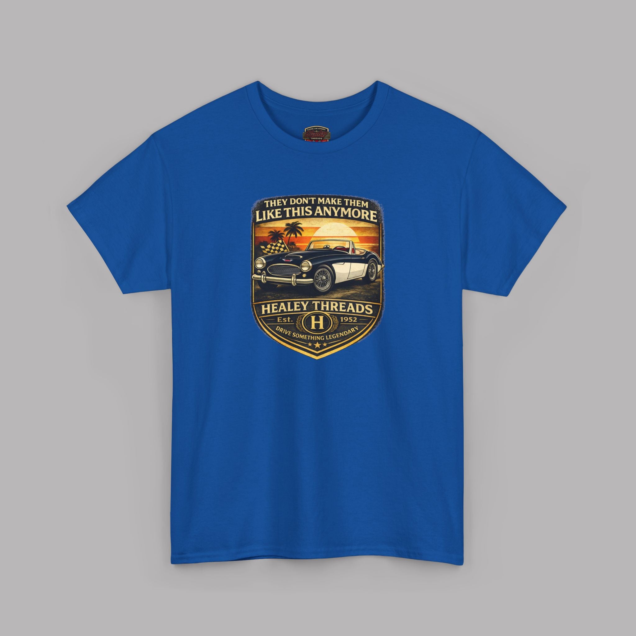 Royal blue t-shirt with a graphic car design on a gray background