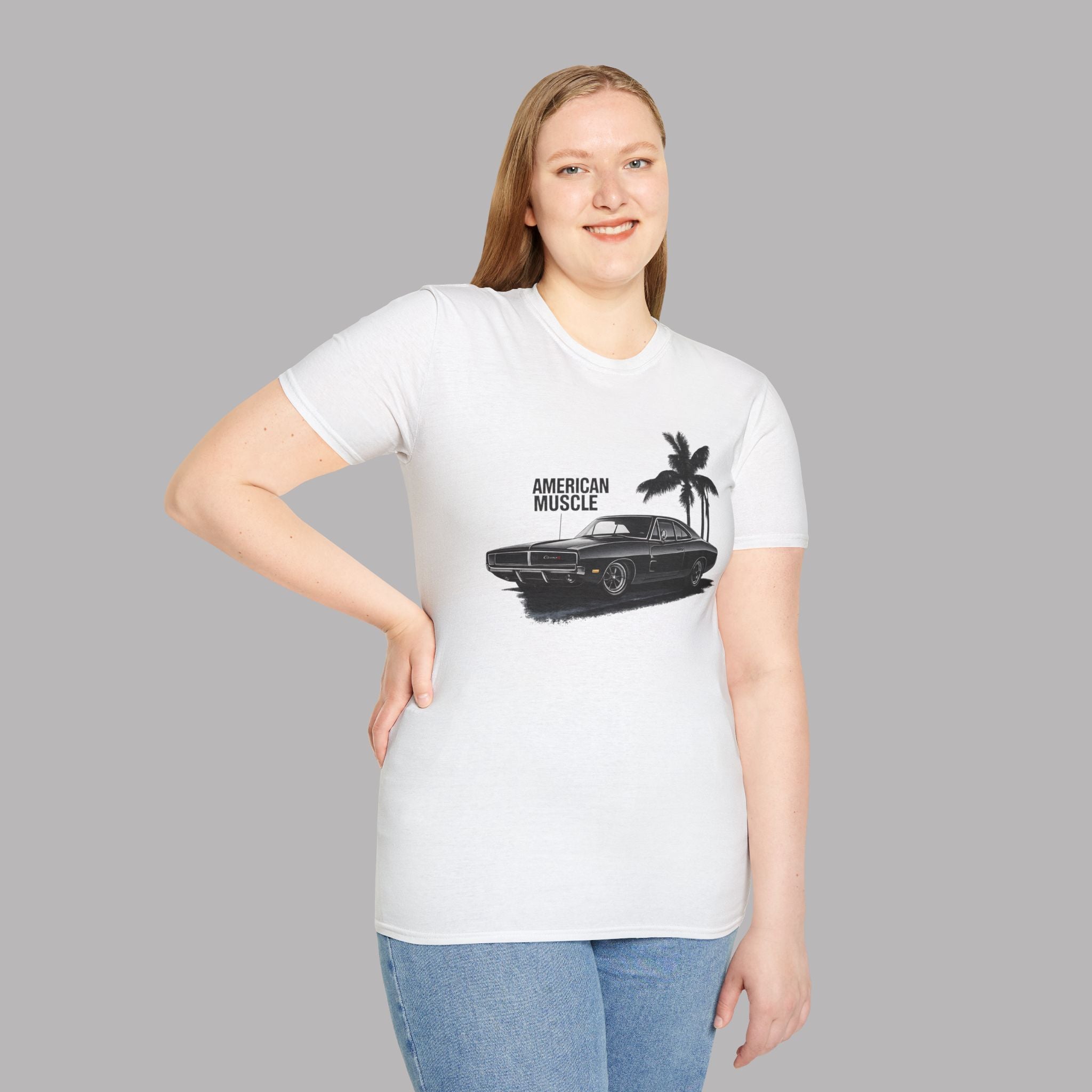 Woman wearing a white t-shirt with a graphic of a muscle car and palm trees on a gray background