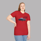 Woman wearing a red t-shirt with a graphic of a classic car and text on a gray background