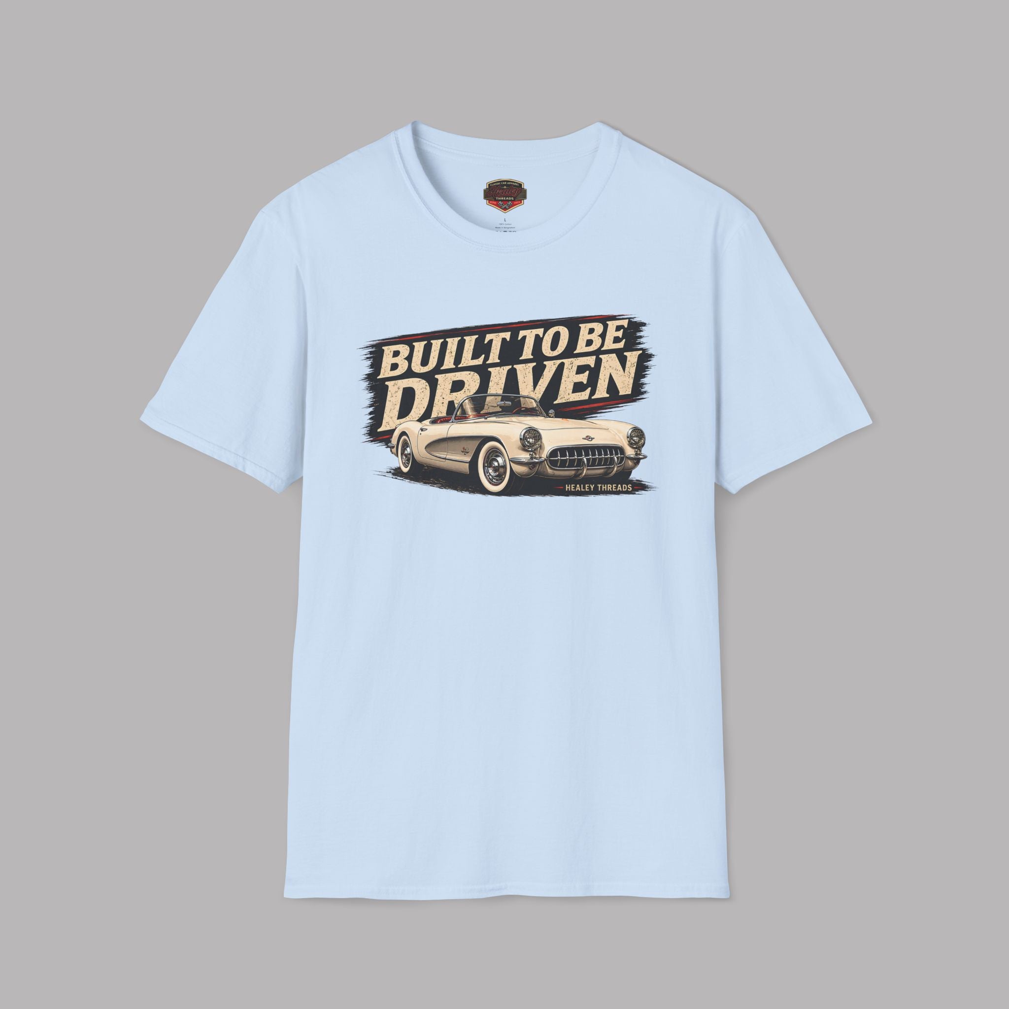 Light blue t-shirt with 'Built to be Driven' graphic on a gray background