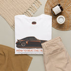 White t-shirt with classic car graphic and text, beige pants, and decorative items on a neutral background