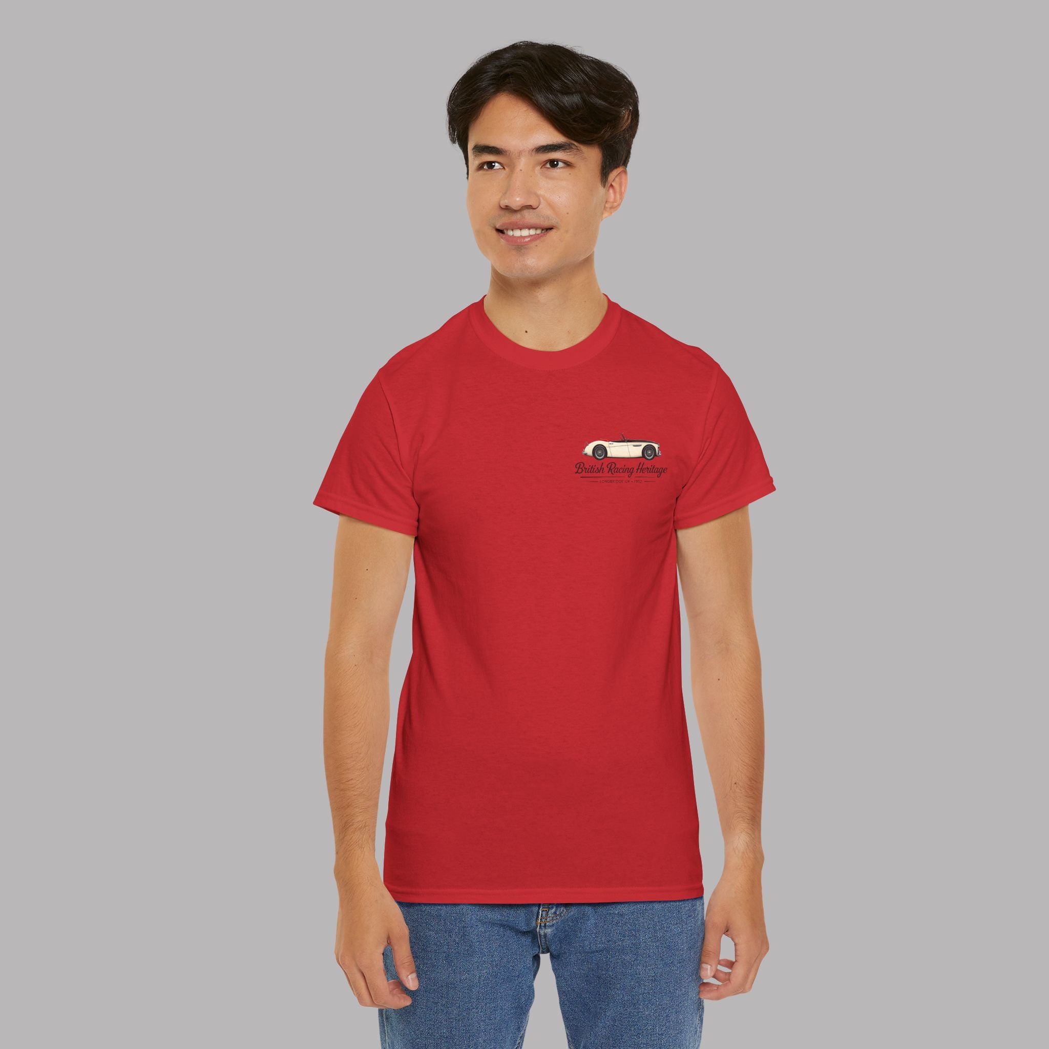 Man wearing a red t-shirt with a Healey car graphic and black text on a gray background