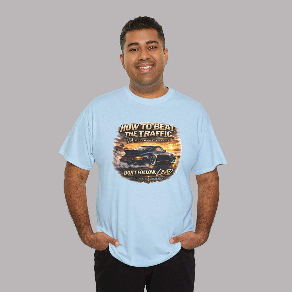 Man wearing a light blue t-shirt with a classic car graphic design and text on a gray background