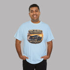 Man wearing a light blue t-shirt with a classic car graphic design and text on a gray background