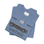 Folded blue t-shirt with vintage car design on a white background