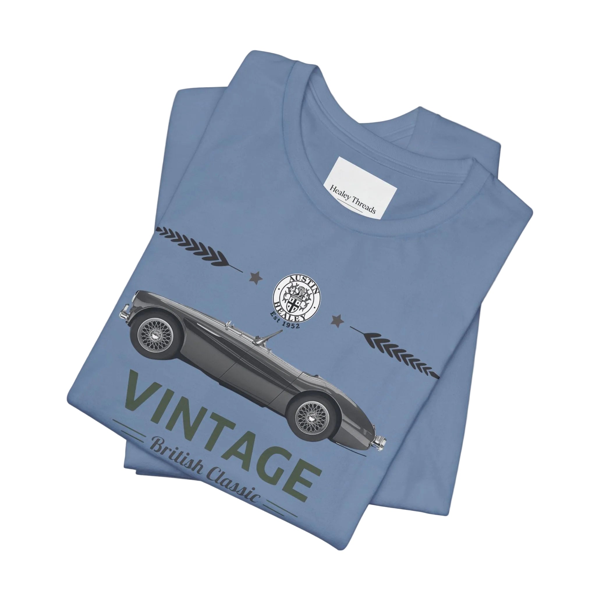 Folded blue t-shirt with vintage car design on a white background
