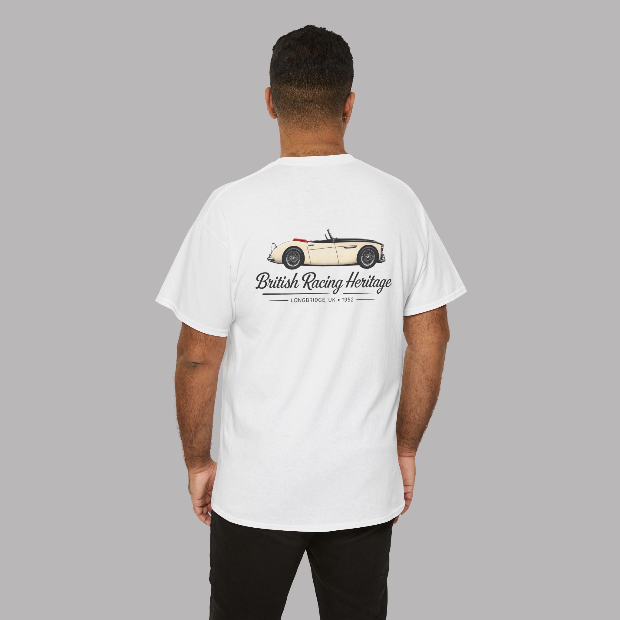 Back of a man wearing a white t-shirt with a Healey classic car graphic design on a gray background