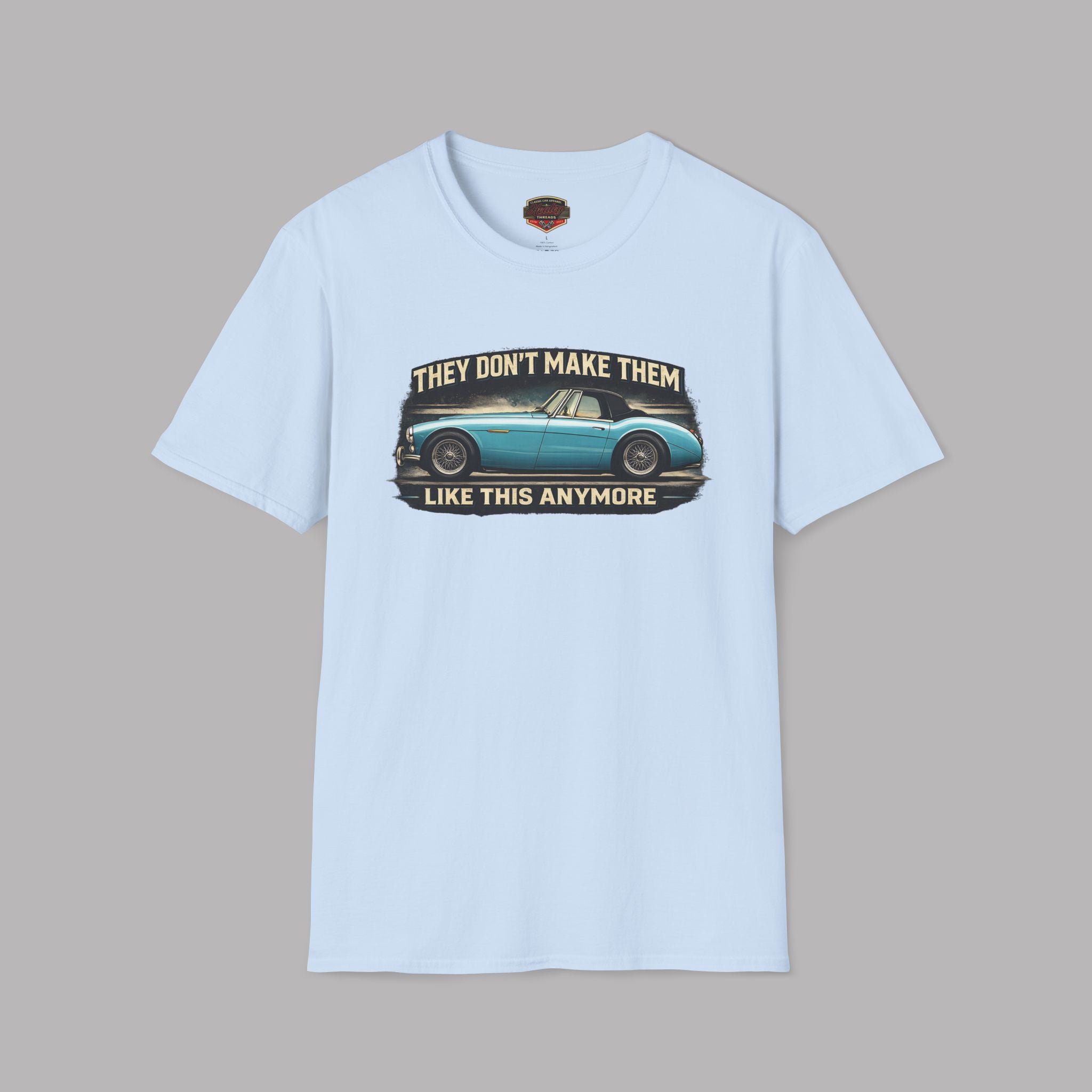 Light blue t-shirt with a graphic of a classic car and text on a gray background