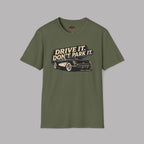 Military green t-shirt with a graphic of a car and text 'Drive it. Don't park it.' on a gray background