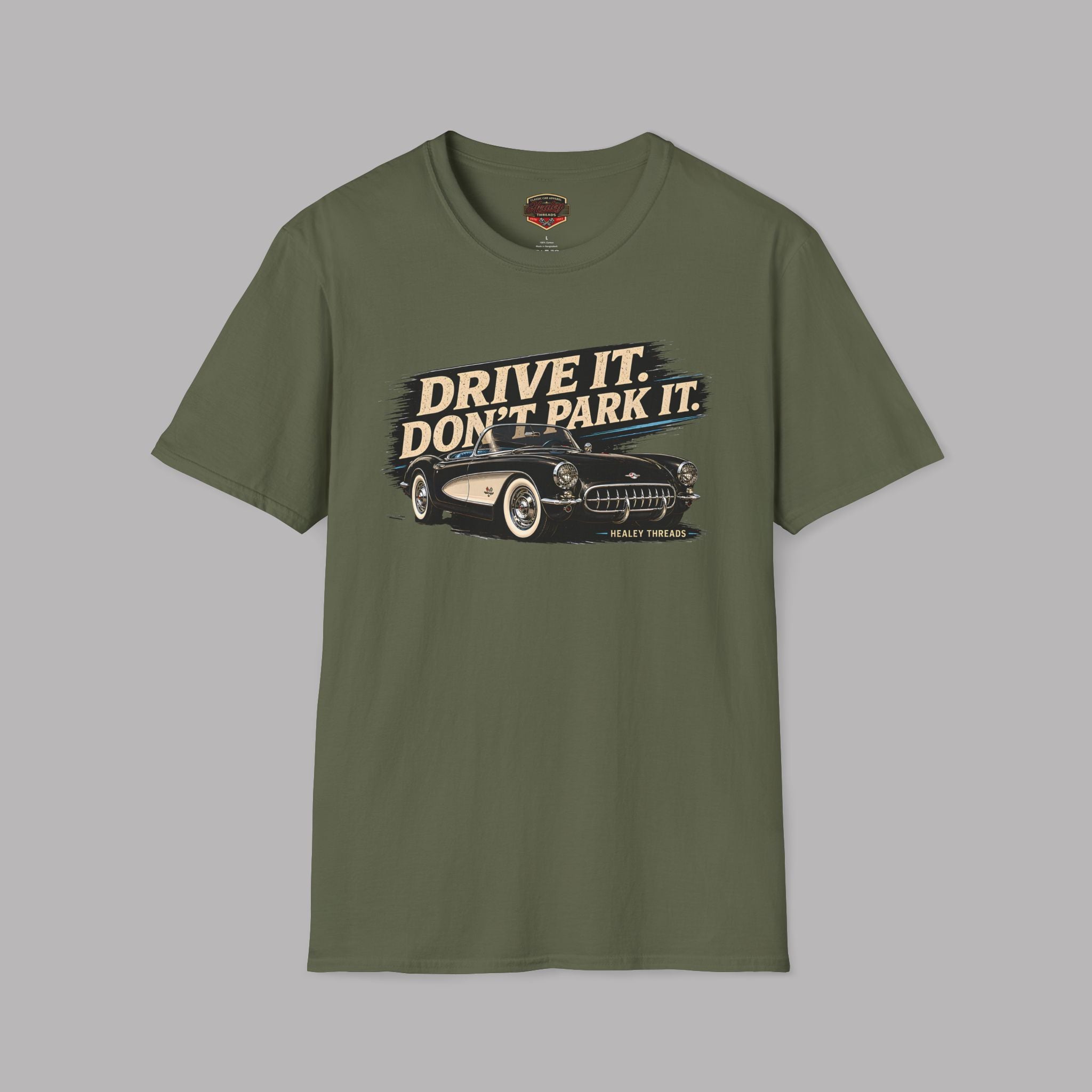 Military green t-shirt with a graphic of a car and text 'Drive it. Don't park it.' on a gray background