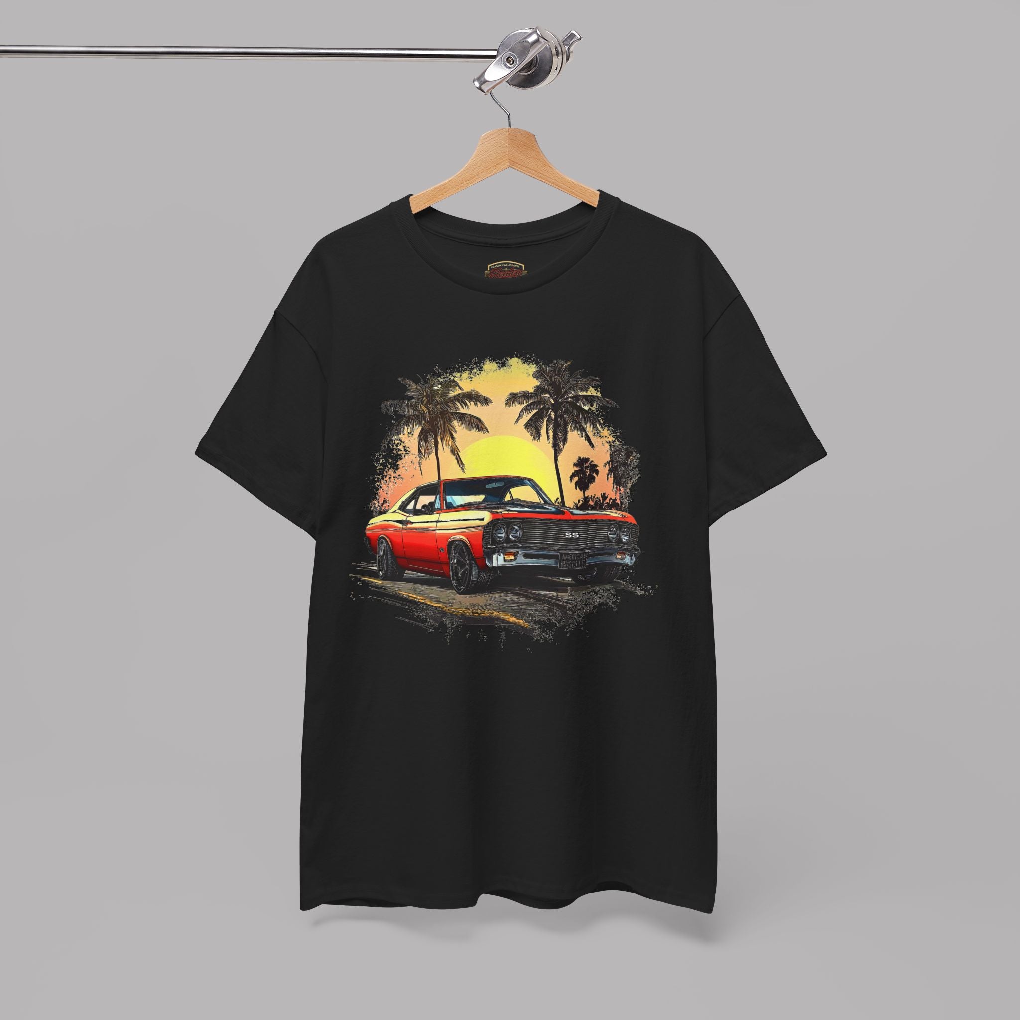 Black t-shirt with a graphic of a classic car and palm trees on a hanger against a gray background