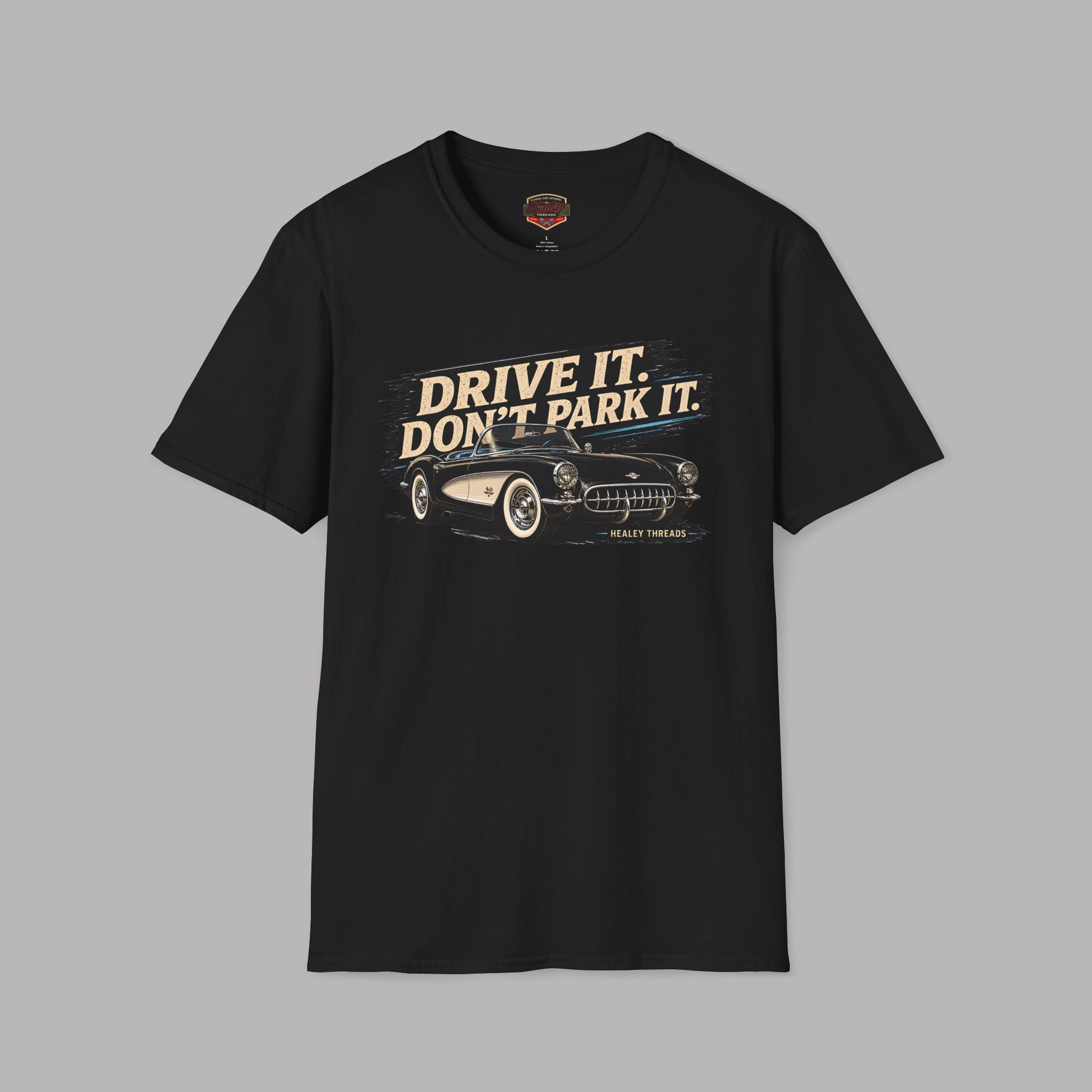 Black t-shirt with vintage car graphic and text 'Drive it. Don't park it.' on a gray background