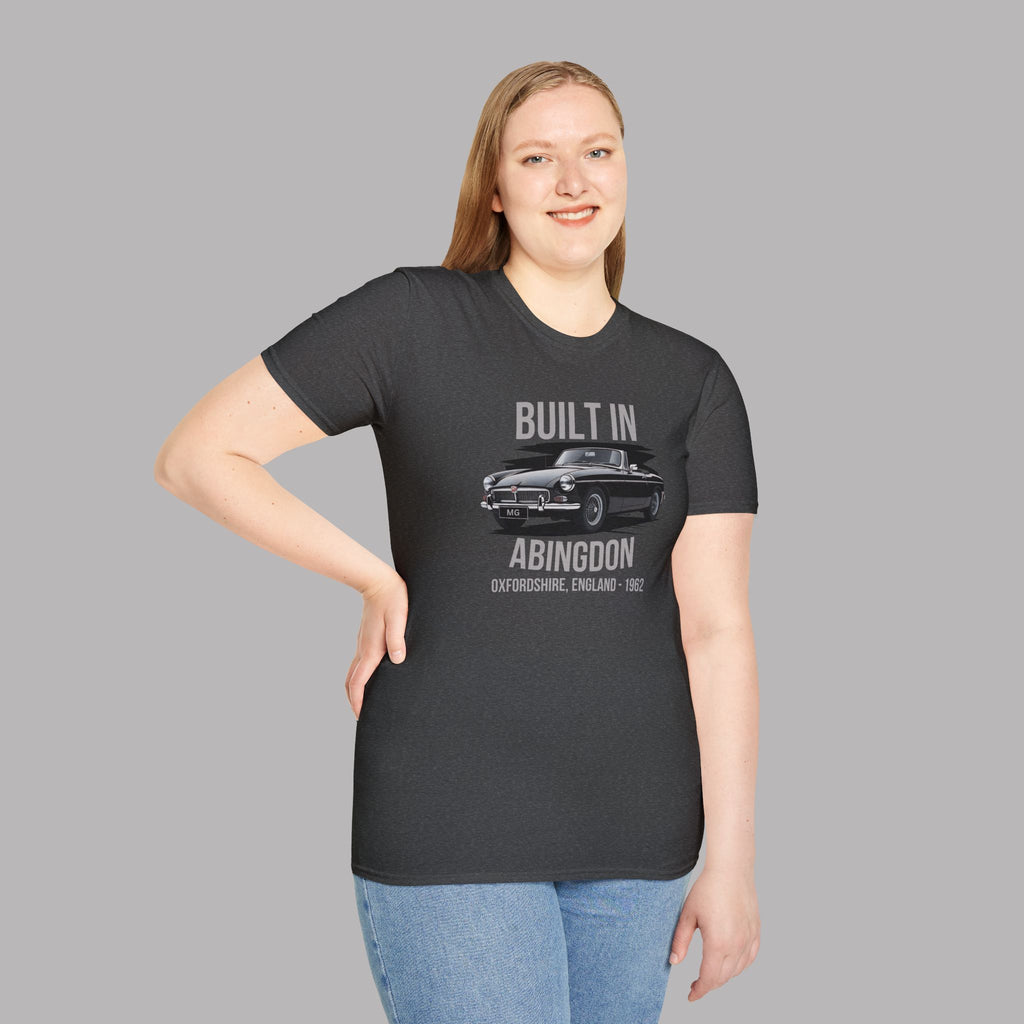 Woman wearing a black t-shirt with a classic car graphic and text on a gray background
