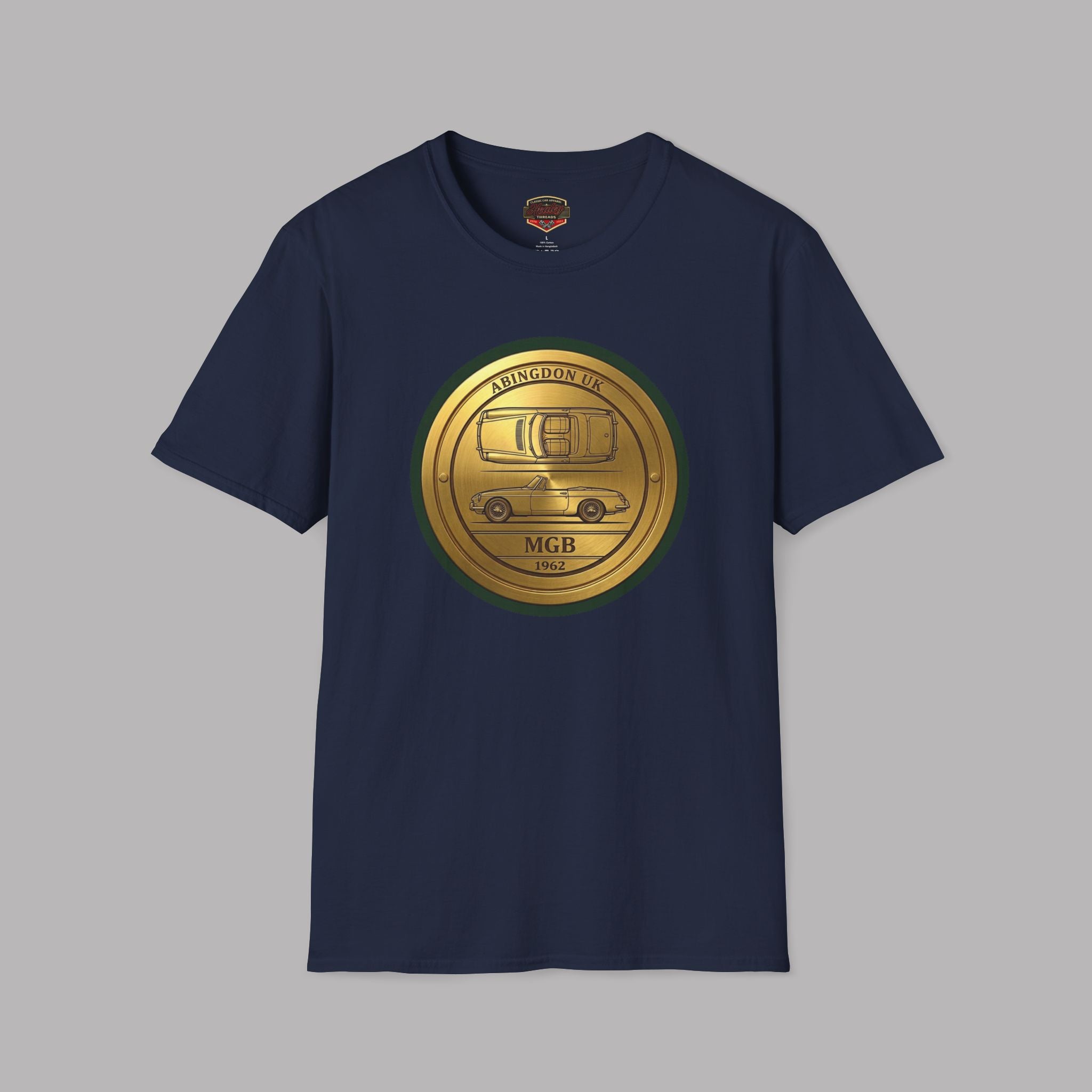 Navy blue t-shirt with a gold circular classic car logo on a gray background