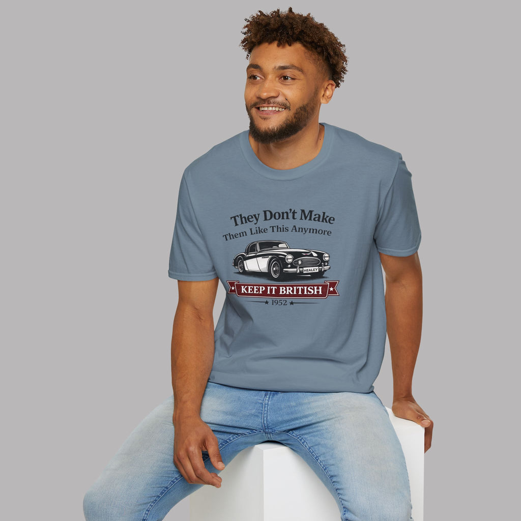 Man wearing a storm blue t-shirt with a graphic car design on a gray background