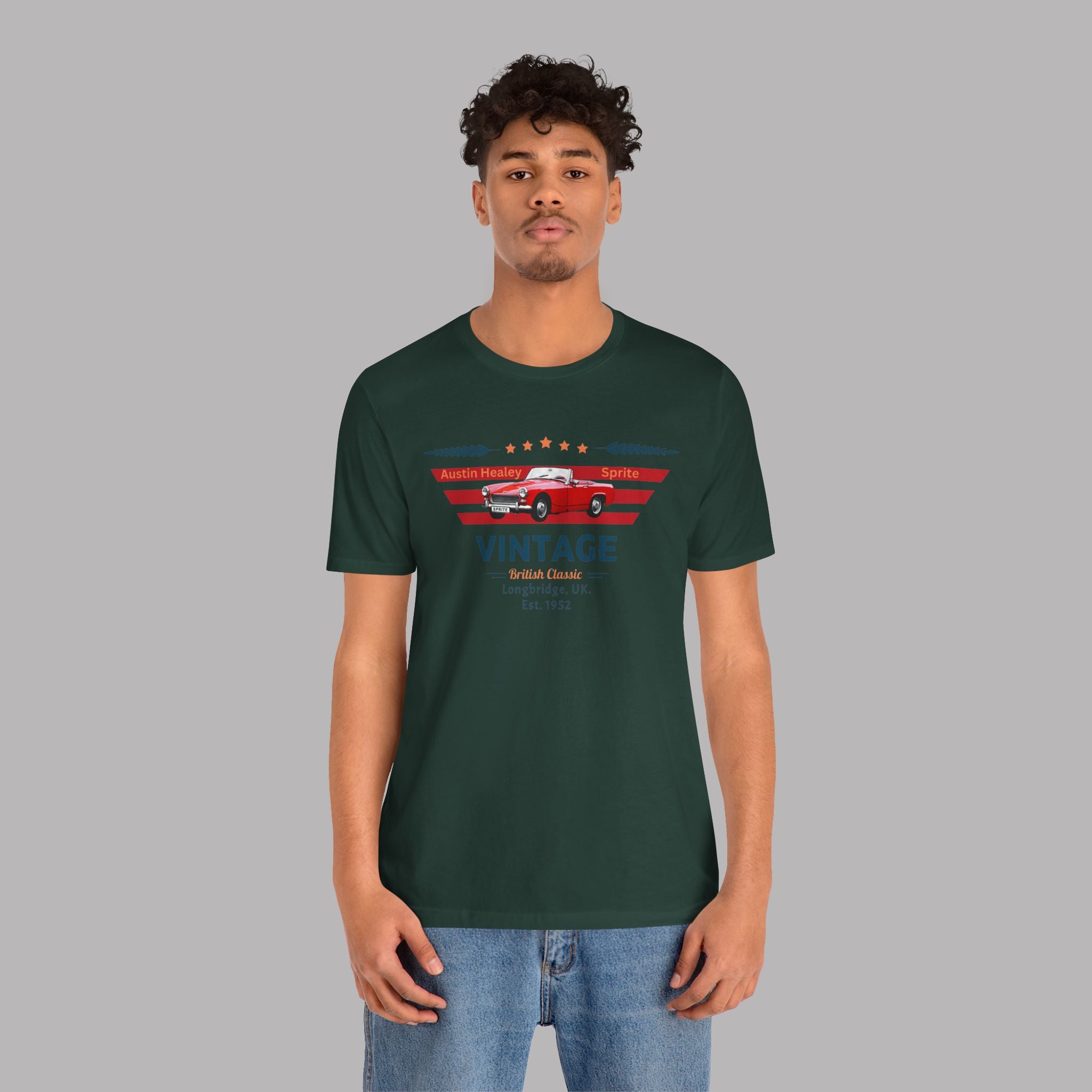 Man wearing a forest green t-shirt with a classic car graphic design on a gray background