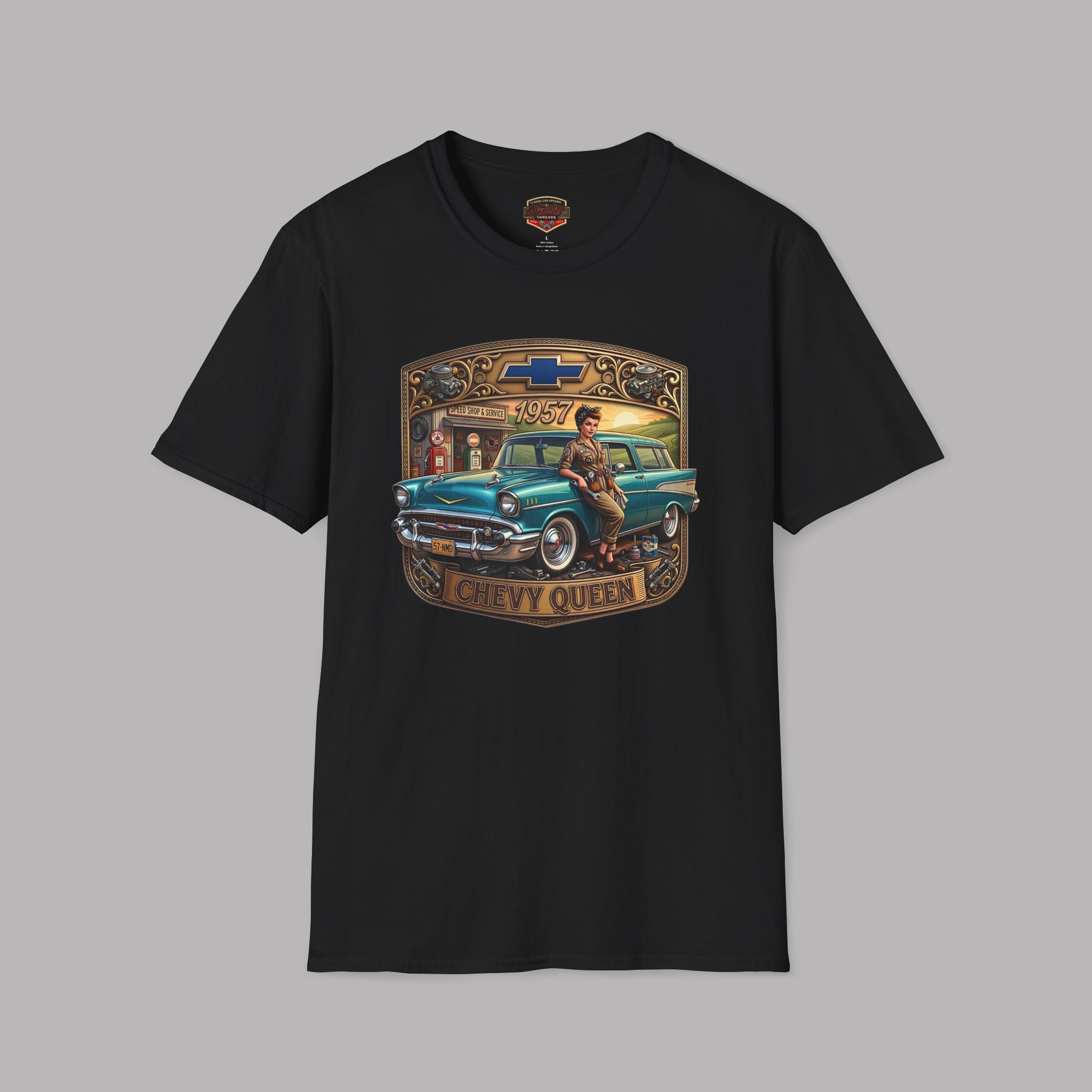 A black short-sleeve crewneck t-shirt featuring a vintage-style graphic print of a teal 1957 Chevrolet station wagon with a woman sitting on it, framed by a gold and brown border with the text 'CHEVY QUEEN'.
