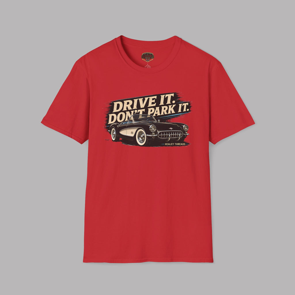 Red t-shirt with a graphic of a vintage car and text 'Drive It. Don't Park It.' on a gray background