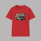 Red t-shirt with a graphic of a vintage car and text 'Drive It. Don't Park It.' on a gray background