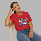 Woman wearing a red t-shirt with a Healey car graphic and text, sitting on a chair against a gray background