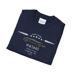 Folded navy blue t-shirt with vintage car design on a white background