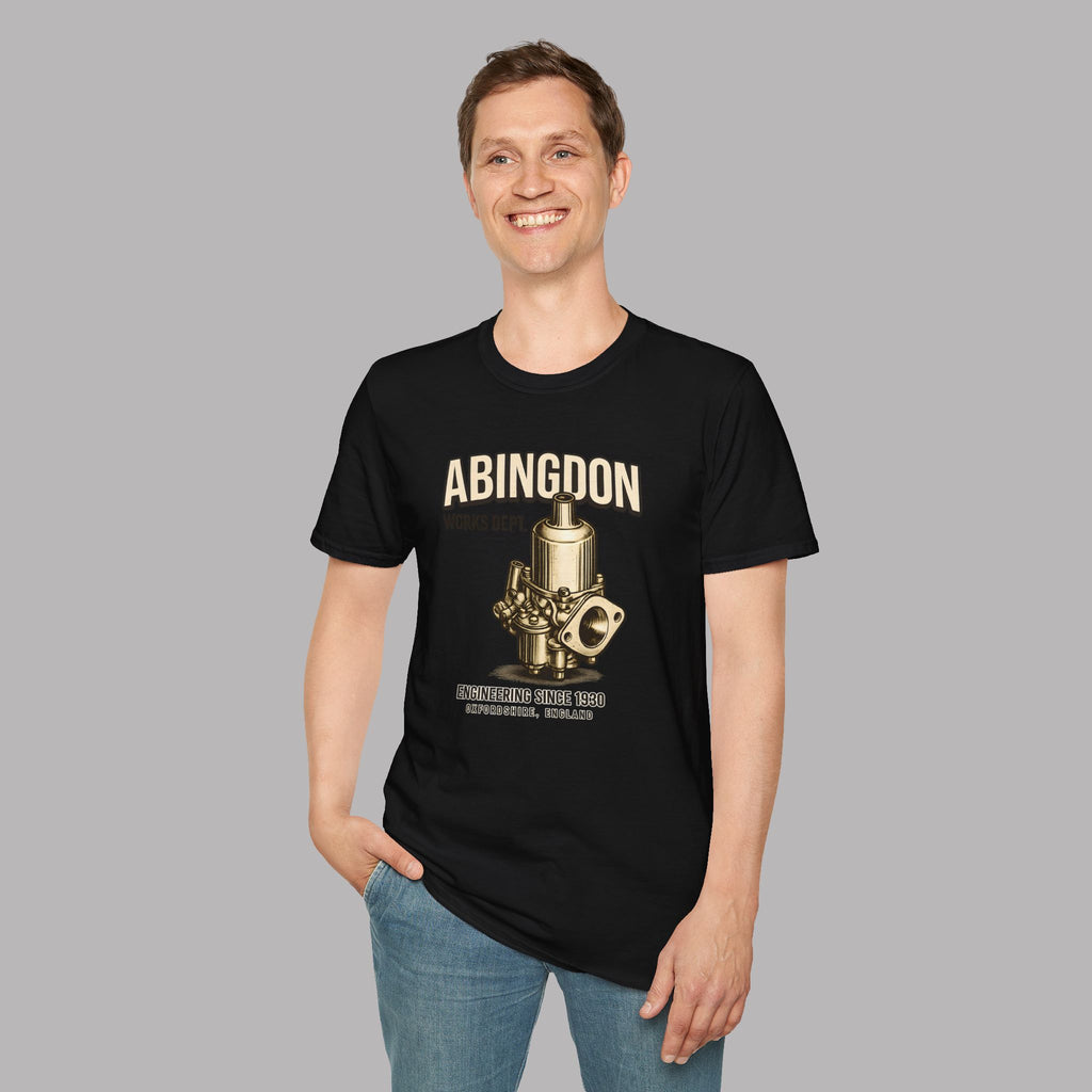 Man wearing a black t-shirt with 'ABINGDON' graphicand a graphic design on a gray background