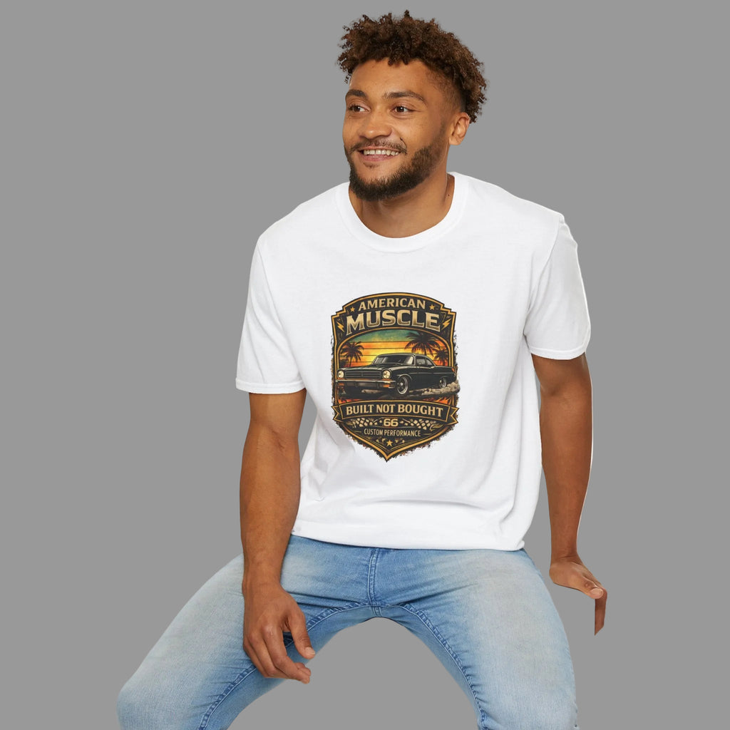 Man wearing a white t-shirt with a classic car graphic design sitting on a white stool against a gray background
