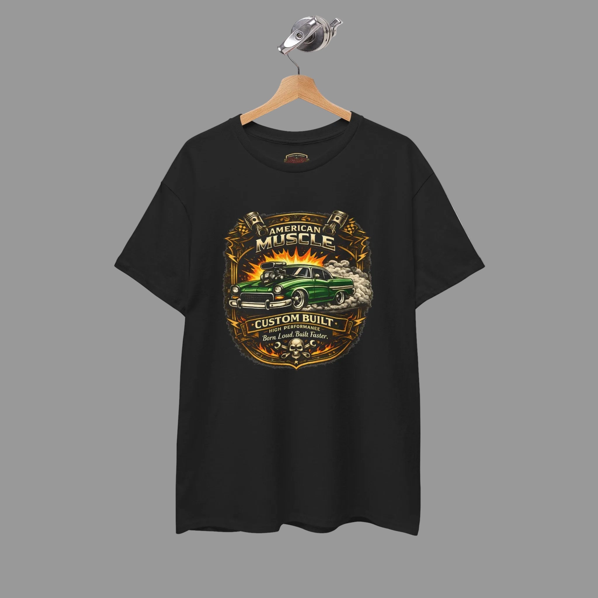 Black t-shirt with a graphic design of a green hot rod car and text on a hanger against a gray background