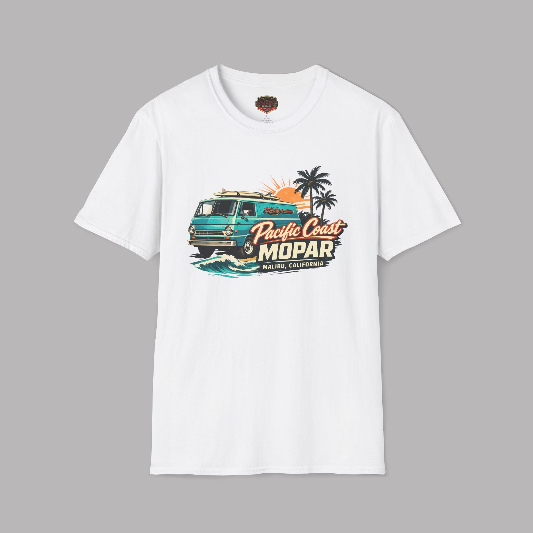 White t-shirt with a colorful graphic van design on a gray background