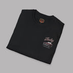 Folded black t-shirt with graphic design on a white background