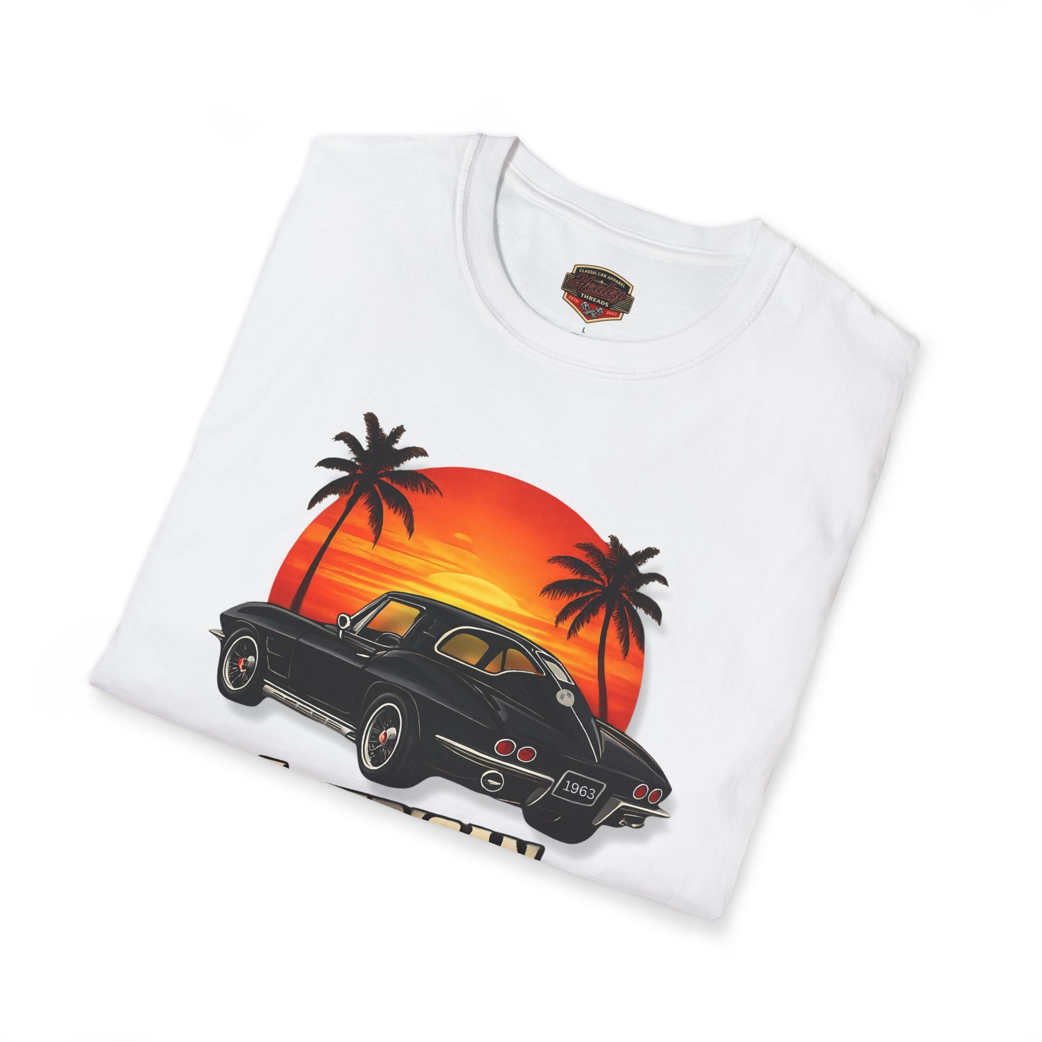 Folded white t-shirt with a car and sunset design on a white background
