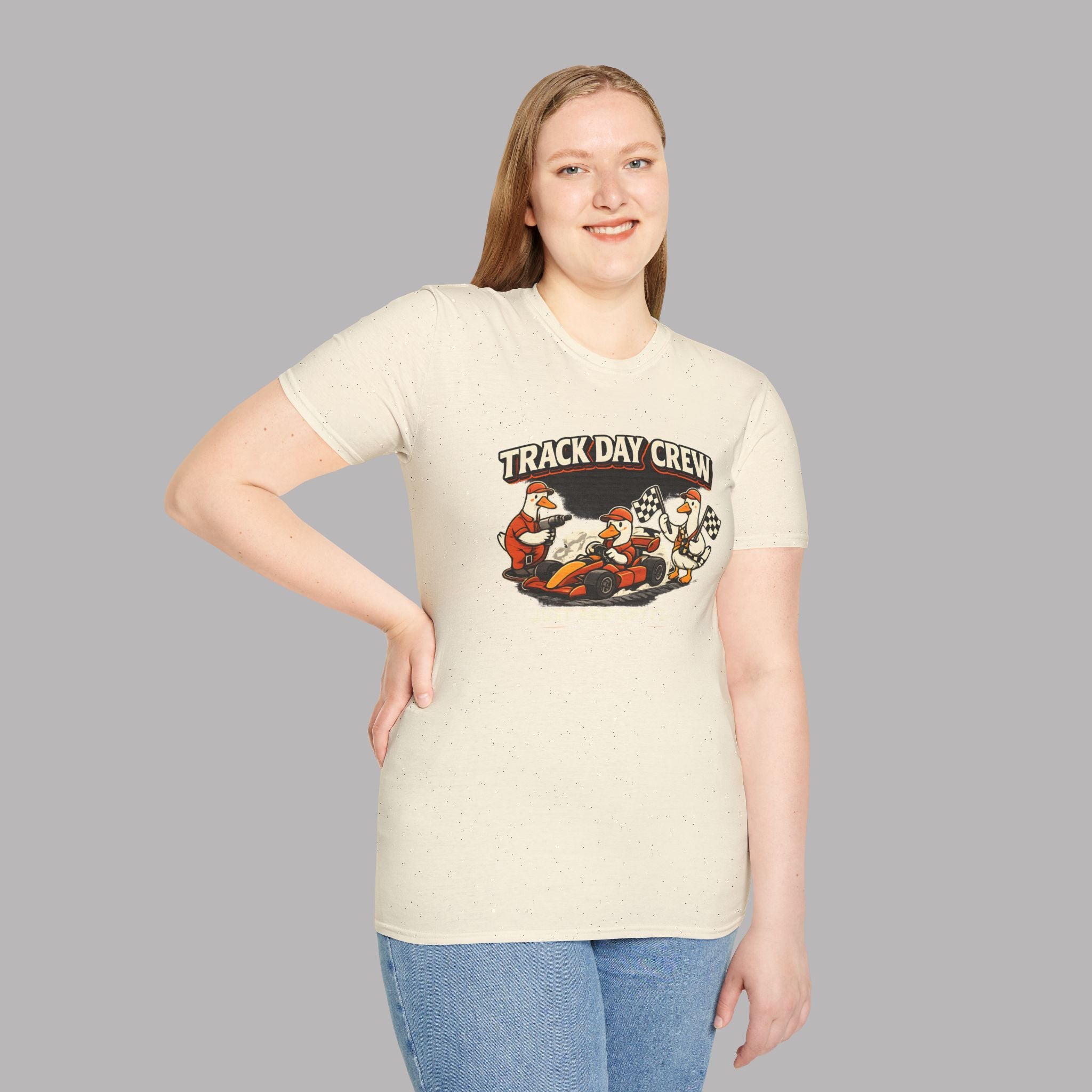 Girl wearing a natural t-shirt with 'Track Day Crew' graphic on a gray background