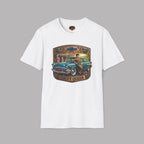 A white short-sleeve crewneck t-shirt featuring a vintage-style graphic print of a teal 1957 Chevrolet station wagon with a woman sitting on it, framed by a gold and brown border with the text 'CHEVY QUEEN'.