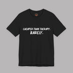  A black t-shirt with white text "Cheaper than therapy. Barely." on a gray background