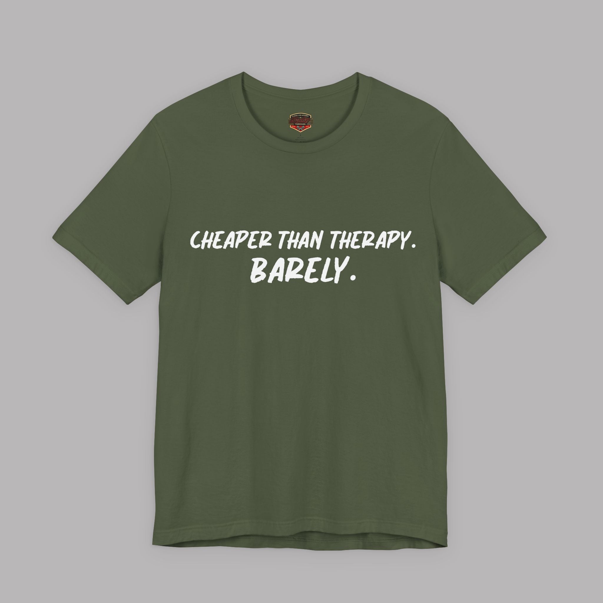  A military green t-shirt with white text "Cheaper than therapy. Barely." on a gray background