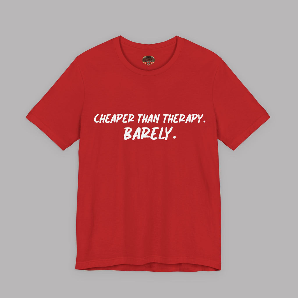A red short-sleeve crewneck t-shirt with the text 'CHEAPER THAN THERAPY. BARELY.