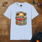 Light blue t-shirt with a graphic design of a van and text 'Livin' the Dream' on a wooden surface.