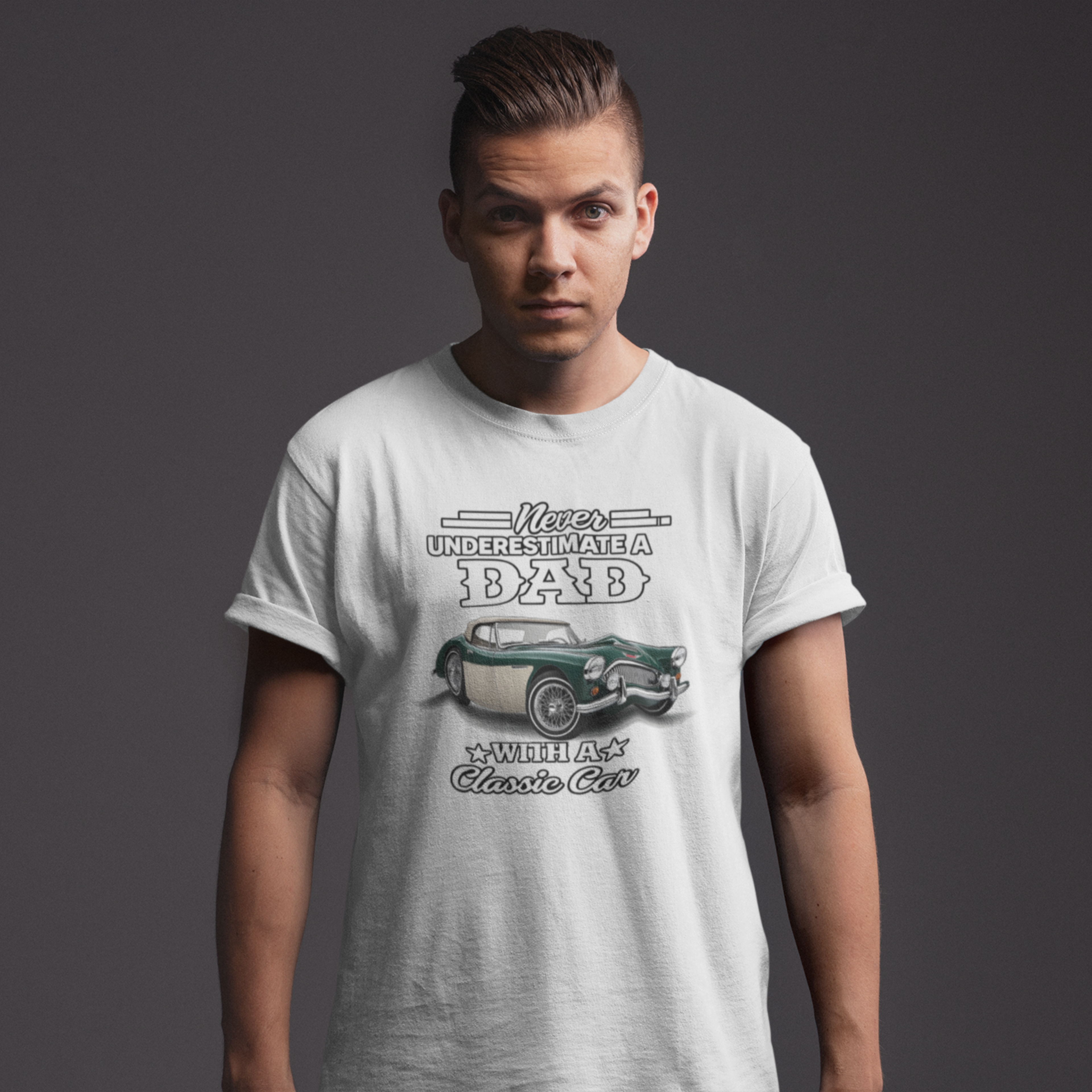 Man wearing a light gray t-shirt with a graphic Healey design and text on a dark background