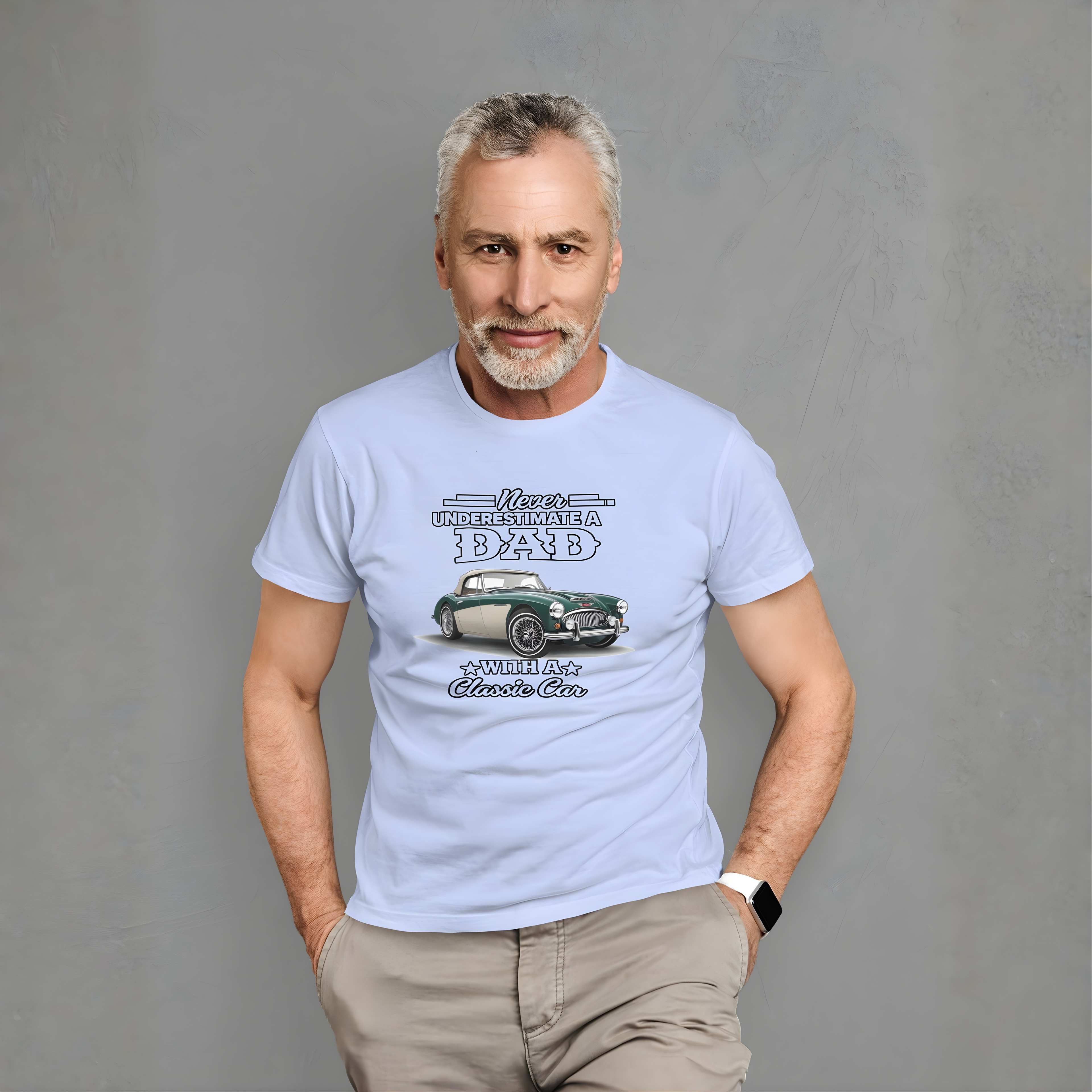 Man wearing a light blue t-shirt with a Austin Healey graphic design on a gray background