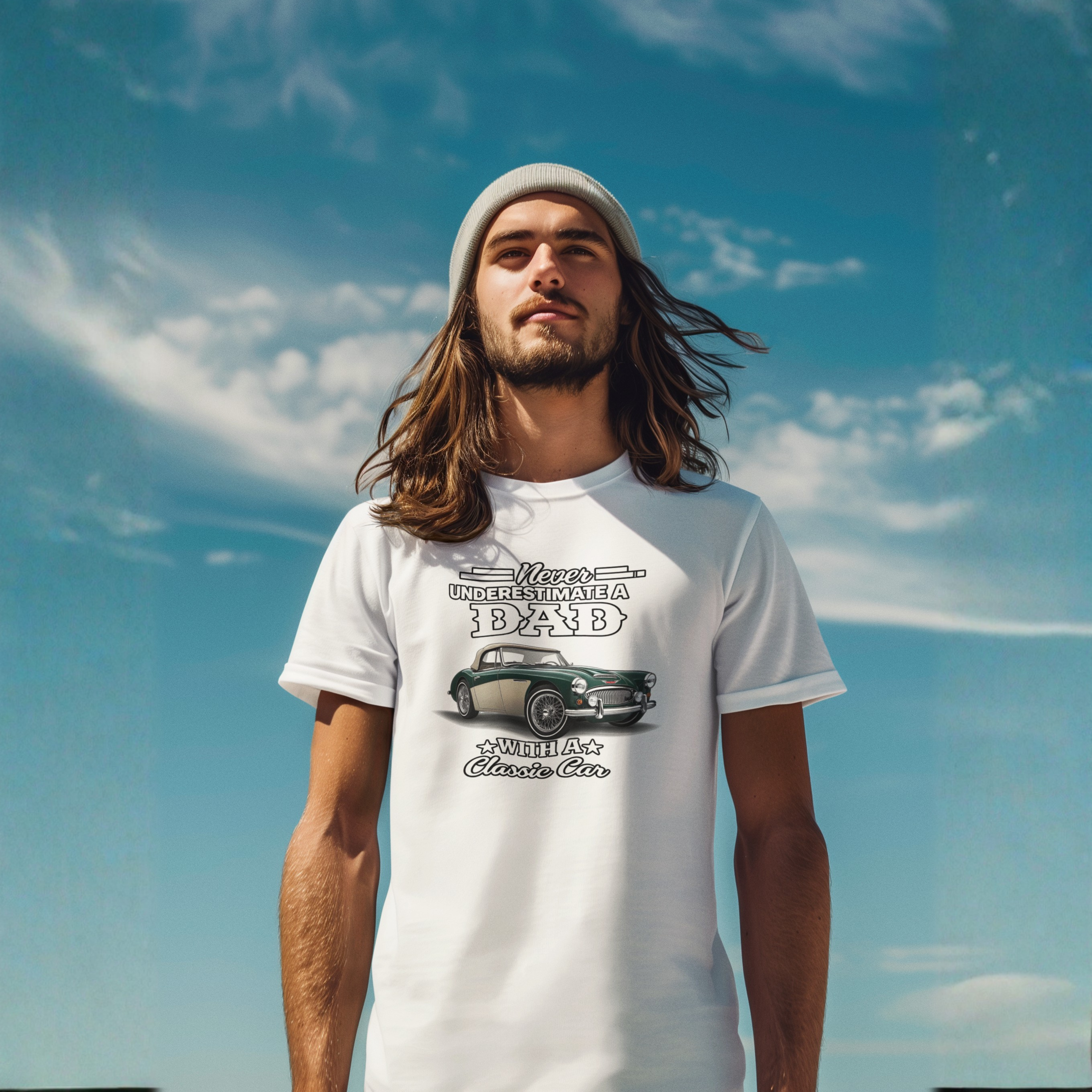 Man wearing a white t-shirt with a graphic Healey design against a blue sky.