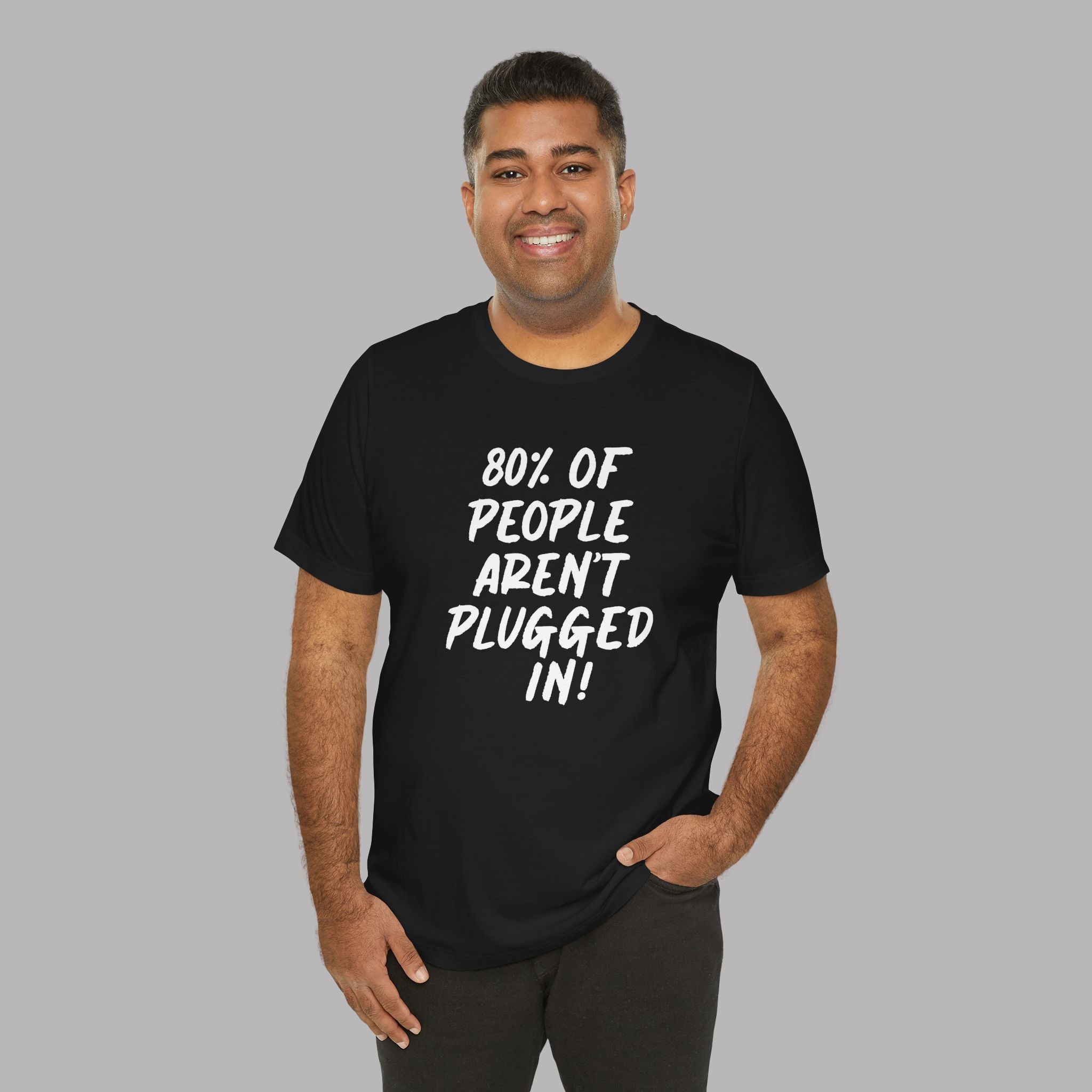 Man wearing a black t-shirt with text "80% of People Aren't Plugged In" on a gray background