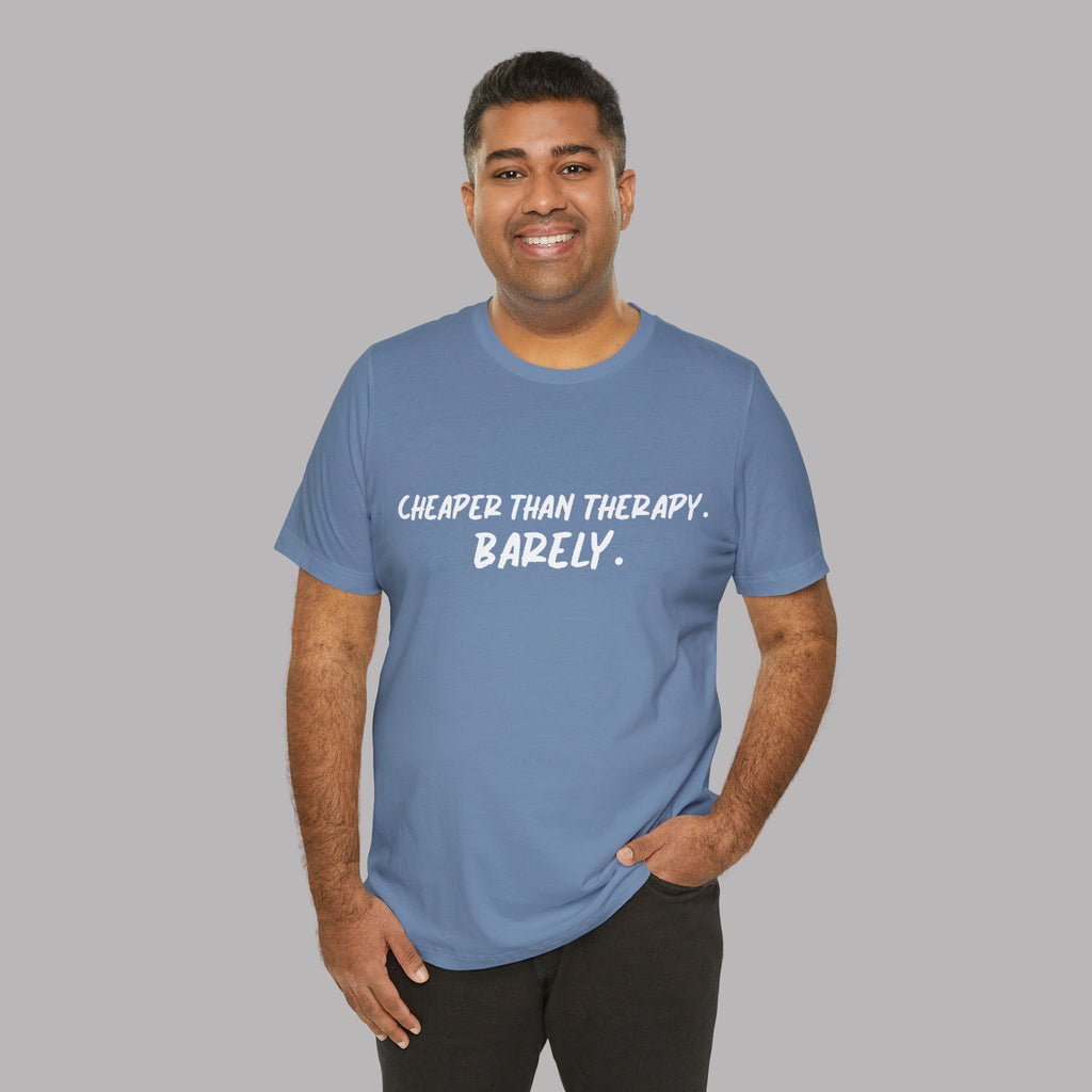 Man wearing a blue t-shirt with  t-shirt with white text "Cheaper than therapy. Barely." on a gray background