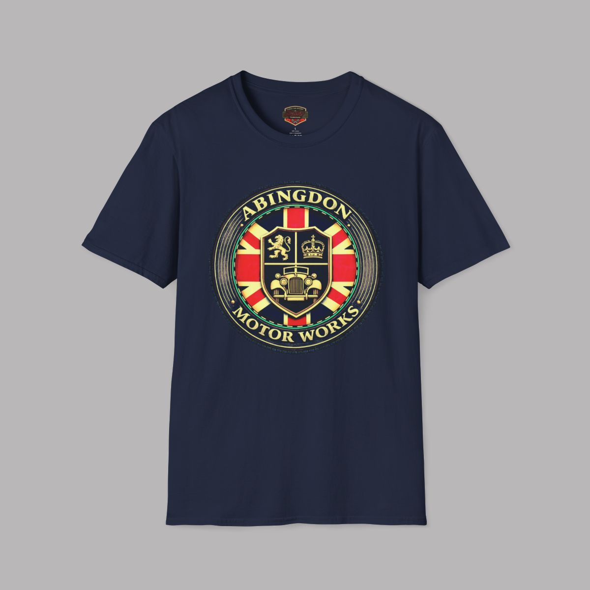 A navy blue short-sleeve crewneck t-shirt featuring a large circular 'Abingdon Motor Works' crest graphic on the chest, displayed against a solid gray background.