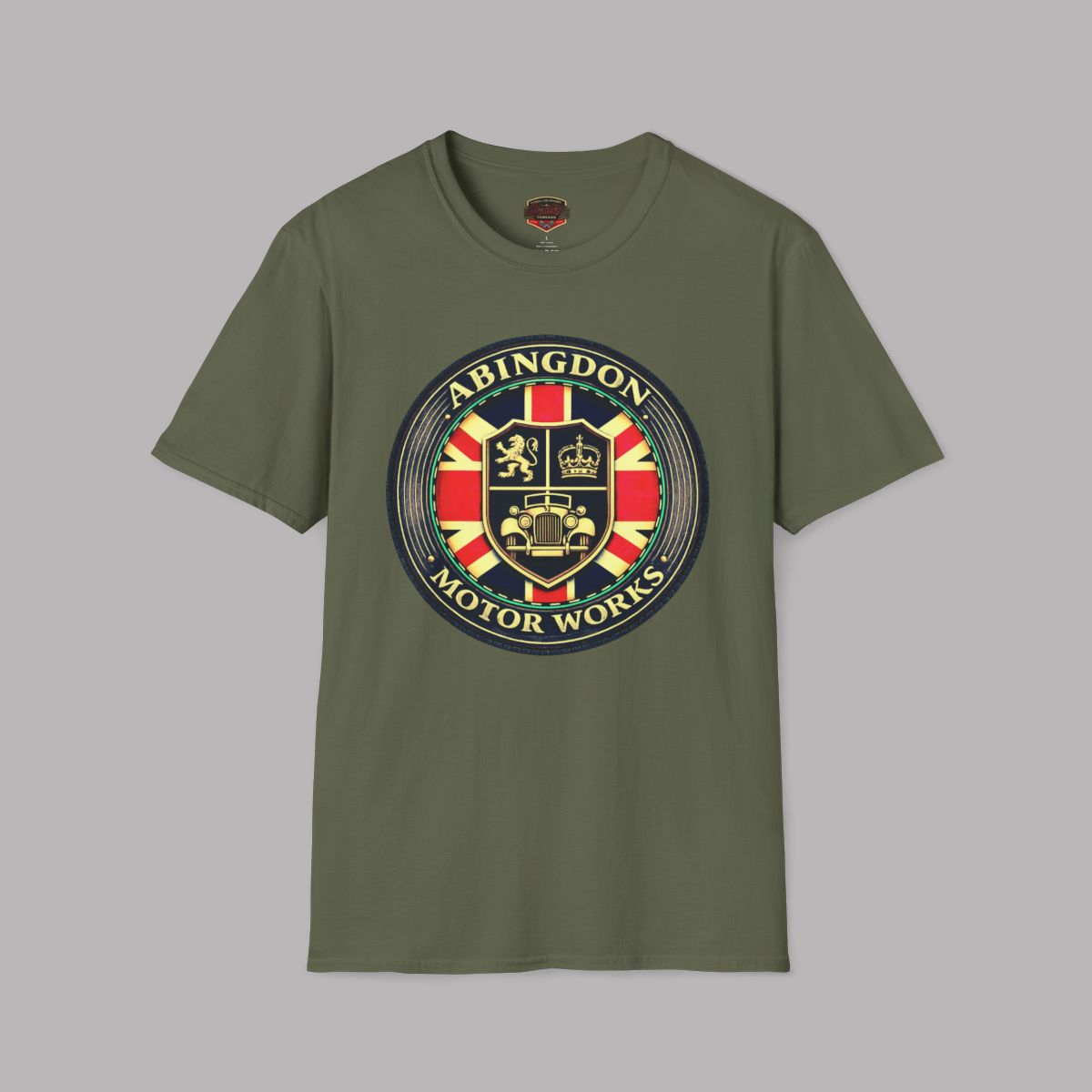 An military green short-sleeve t-shirt with a circular 'Abingdon Motor Works' crest graphic printed on the chest, displayed against a solid gray background.
